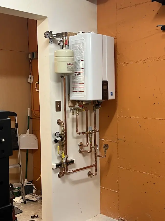 Plumbing technician inspecting water heater connections in Greenbelt